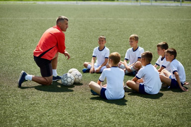 coach-instructing-junior-football-team-scaled